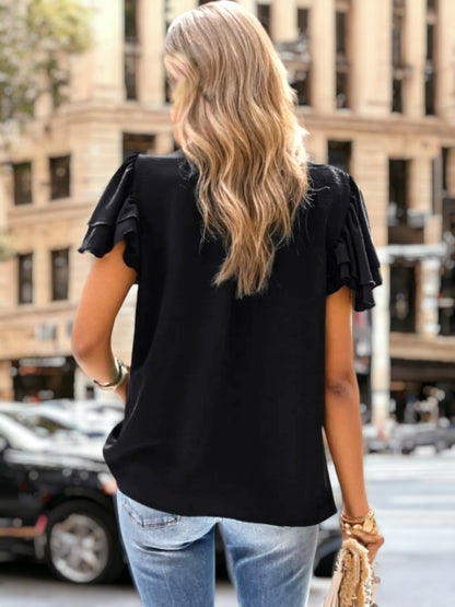 Blusa con detalle plisado y mangas abullonadas