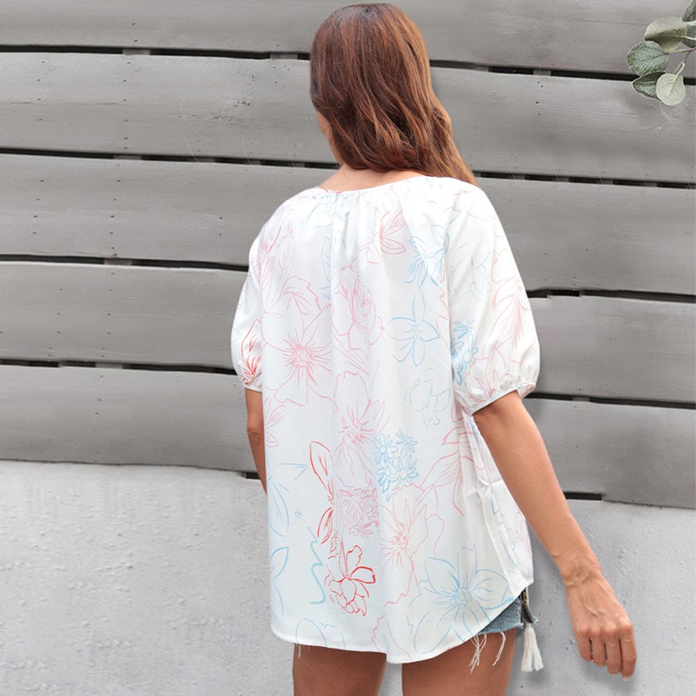 Blusa floral con lazo en el cuello y borlas