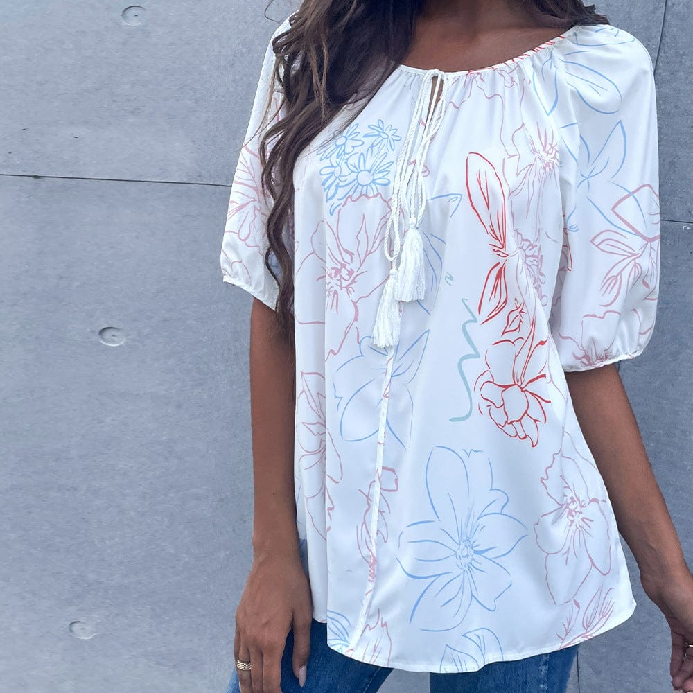 Blusa floral con lazo en el cuello y borlas