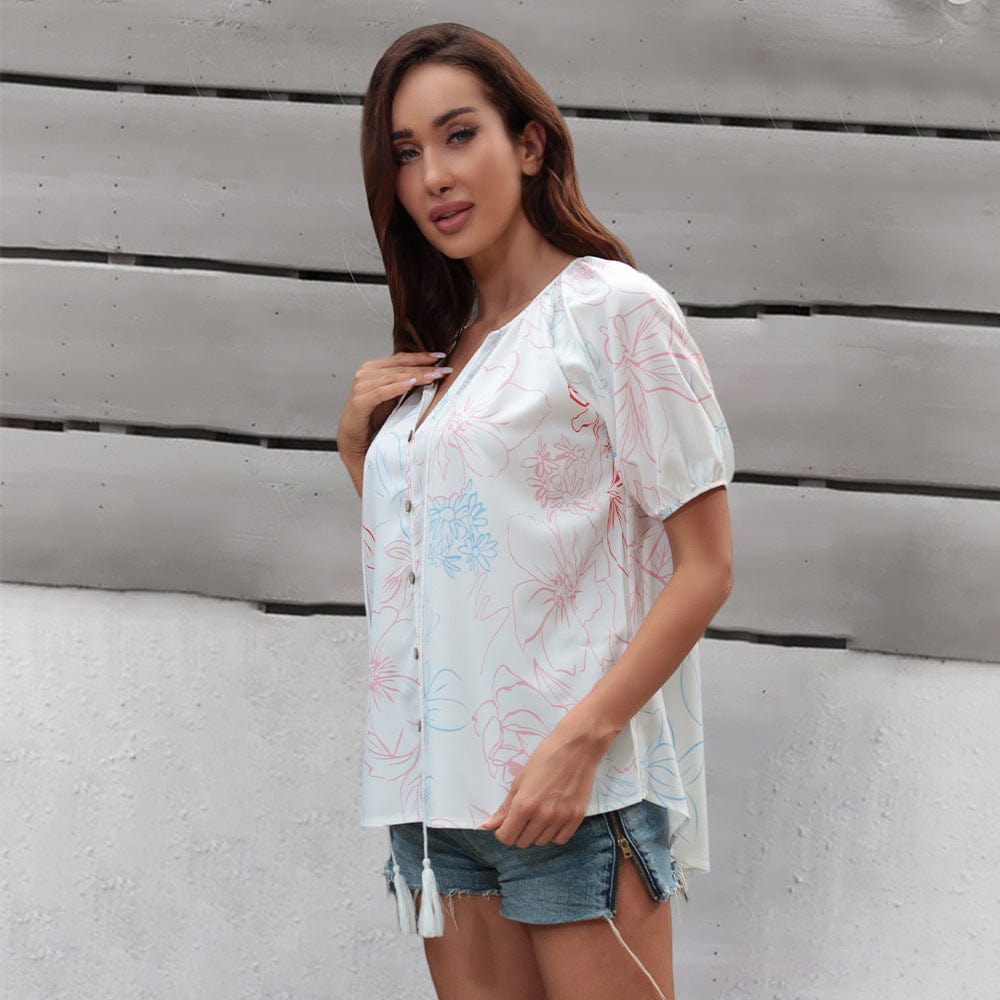 Blusa floral con lazo en el cuello y borlas